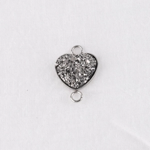 Macro shot of 13mm heart-shaped stainless steel pendant with sparkling crystal inlay