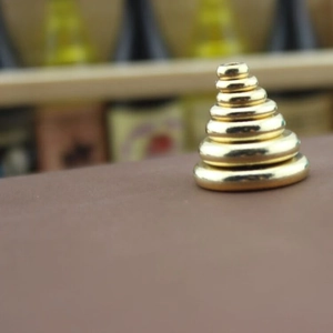 Macro view of solid brass flat abacus spacer beads for DIY jewelry making and necklace crafts
