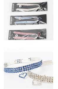 Macro detail of elastic pet jewelry collar with triple-row rhinestones and heart pendant