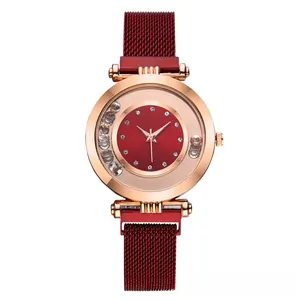 Detail of red dial watch with rose gold case and sparkling floating rhinestones
