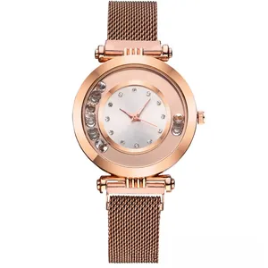 Detail of rose gold ladies' watch with mesh strap and sparkling crystals on the dial