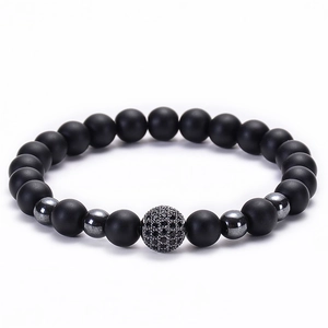 Detail showing matte black beads and a micro-pave zircon ball on the stretch bracelet