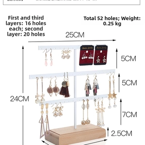 Three-tier jewelry stand with white metal bars and wooden base showing 52 storage holes