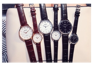 Detail view of KEZZI quartz watches with leather straps in brown and black finishes