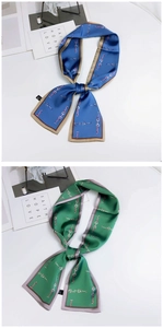 Detailed macro view of blue and green silk twilly scarves with horsebit chain patterns