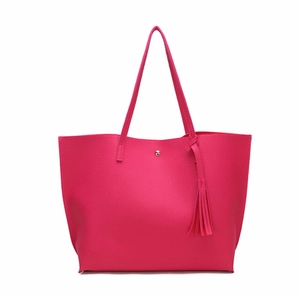 Detail of lychee textured tote bag in magenta with tassel charm and metallic closure