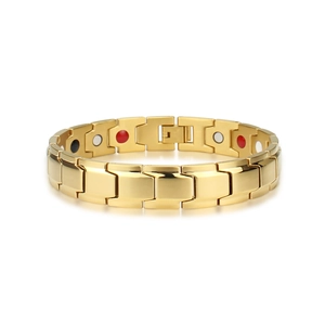 Detail of gold magnetic therapy bracelet featuring inset red black and white energy stones
