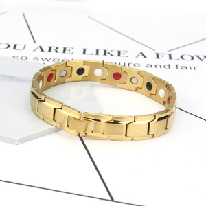 Men's magnetic therapy bracelet in gold finish with healing stones on white card