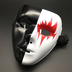 Macro detail of black and white mask with red flame design and adjustable elastic strap