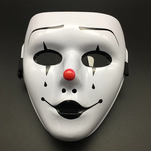 Detailed view of white clown mask with red nose and black painted facial patterns