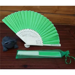 Green folding fan with white hollow bone and matching drawstring organza storage bag