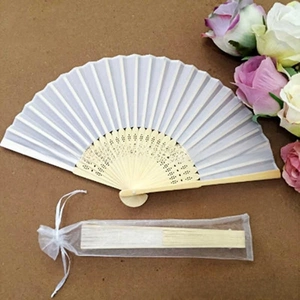 Detail of white fabric folding fan with bamboo ribs and matching organza drawstring bag