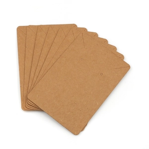 Stack of brown kraft paper jewelry display cards with pre-cut holes and hanging slots