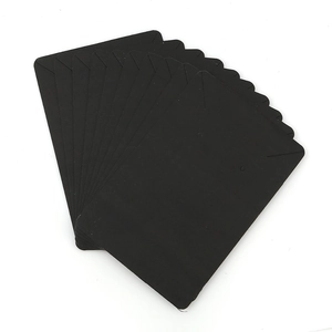 Stack of black cardboard jewelry display cards for earrings and necklaces on white background