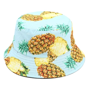 Detailed view of bucket hat fabric texture with tropical pineapple print and precise stitching