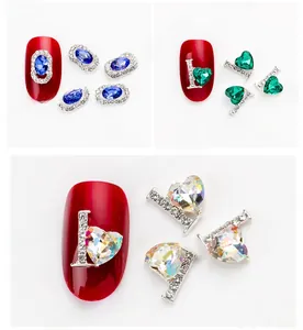Detailed macro view of heart and oval luxury rhinestones on red nails with silver bases