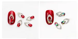 Detailed view of teardrop alloy nail rhinestones in deep red and AB crystal colors