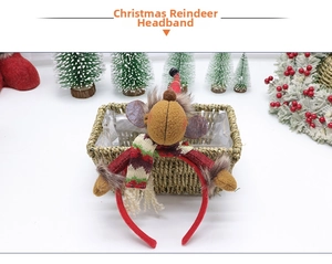 Detail of Christmas reindeer headband with mini Santa hat and red scarf in festive setting