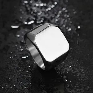 Macro shot of polished silver stainless steel square signet ring for men on water drops
