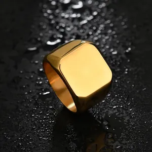 Macro shot of polished gold-plated stainless steel signet ring on a wet black surface