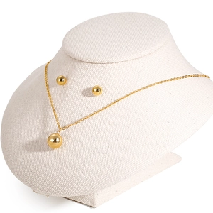 Minimalist 18K gold-plated stainless steel jewelry set with ball pendants on beige bust