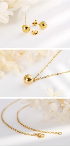 Detailed view of 18K gold plated bead earrings and matching necklace set with dry flowers