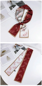 Detail of burgundy and cream long skinny scarf with artistic line art pattern and silk sheen