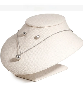 Detailed view of polished stainless steel round bead necklace and stud earrings set
