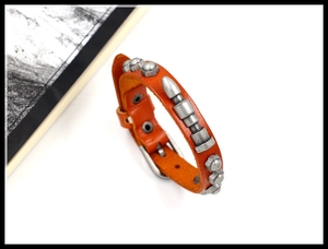 Detail of vintage brown leather punk bracelet with silver studs and metal buckle closure