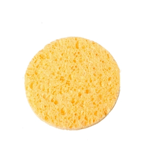Close-up of a round yellow cellulose face sponge with porous texture on a white background