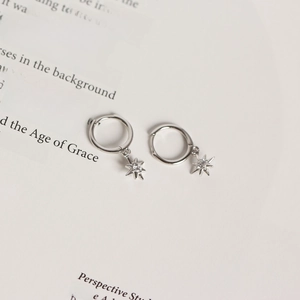 Detailed close-up of S925 sterling silver star drop earrings with sparkling cubic zirconia