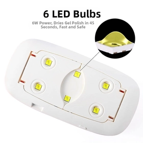 Detail view of the 6 LED beads and foldable stand of this white 6W portable nail lamp
