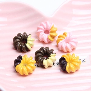 Colorful resin donut charms for DIY phone cases, set of six in a pink shell plate