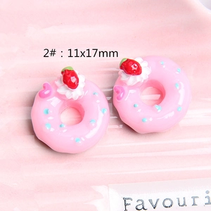 Macro shot of 11x17mm pink resin donuts with strawberry cream for DIY crafts