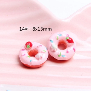 Macro shot of 8x13mm pink resin donuts with strawberry and sugar beads for DIY crafts