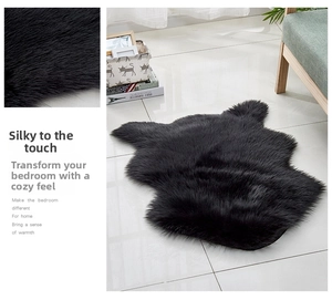 Detail of soft black faux fur rug with shaggy texture and irregular organic shape