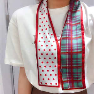 Detail of double-sided skinny scarf with red polka dots, plaid pattern and red piping