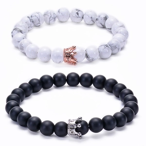 Detail of white marble and black matte crown beads bracelets for couples and lovers