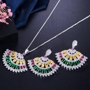 Silver jewelry set with fan-shaped multicolor gemstone earrings and necklace on black background