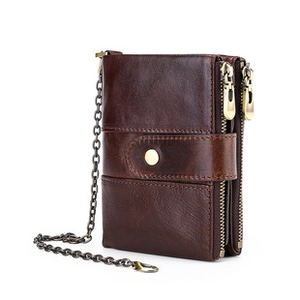 Detail view of dark brown leather wallet with double zippers and metal anti-theft chain