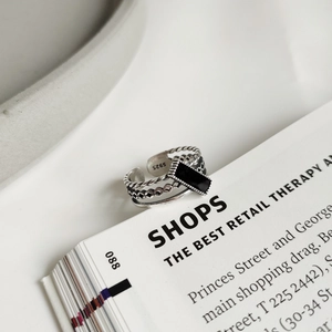 Macro detail of S925 sterling silver stamp and retro woven texture on vintage black ring