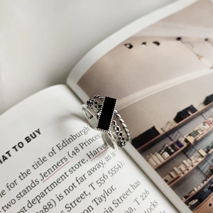 Macro detail of retro 925 silver layered ring with black rectangular enamel stone inlay