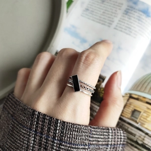 Macro shot of 925 silver retro ring with layered bands and black rectangular inlay