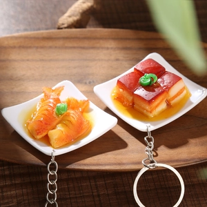 Miniature food keychains featuring braised pork and fish dishes in white bowls