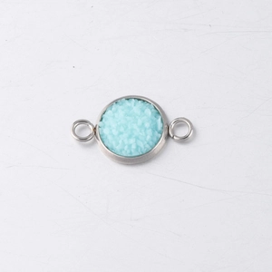Macro view of a 10mm stainless steel drusy connector with light blue resin inlay for DIY jewelry