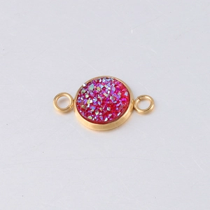 Detailed macro of gold-plated stainless steel star pendant with glittering red inlay