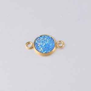 Close-up of 10mm gold stainless steel charm with sparkling blue resin and dual loops