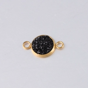 Macro shot of 10mm gold vacuum plated stainless steel connector with black gemstones