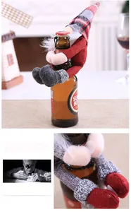 Detail of Christmas gnome wine bottle cover with red knitted hat and faux beard
