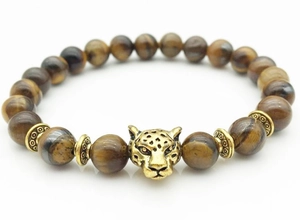 Detail of beaded bracelet featuring tiger eye stones and a golden leopard head charm